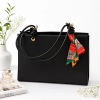  کیف دوشی زنانه چرمی طرح کنفی با دسته گره‌ای به همراه اسکارف تزئینی و کیف لوازم آرایش